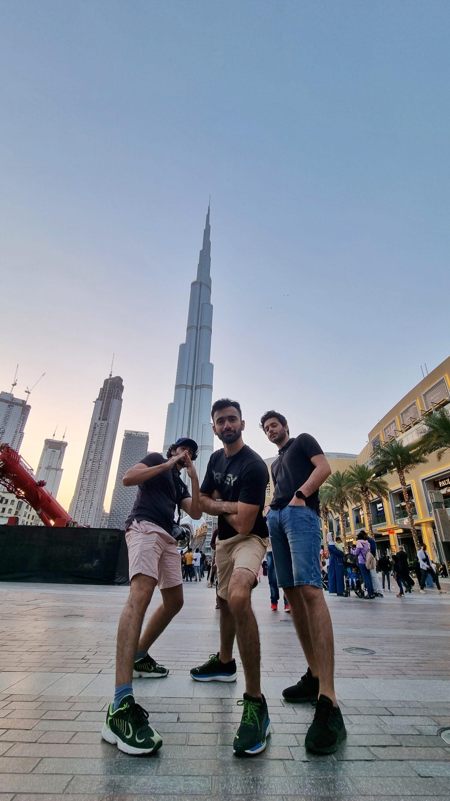 Founders posing in front of a skyline at an outdoor plaza
