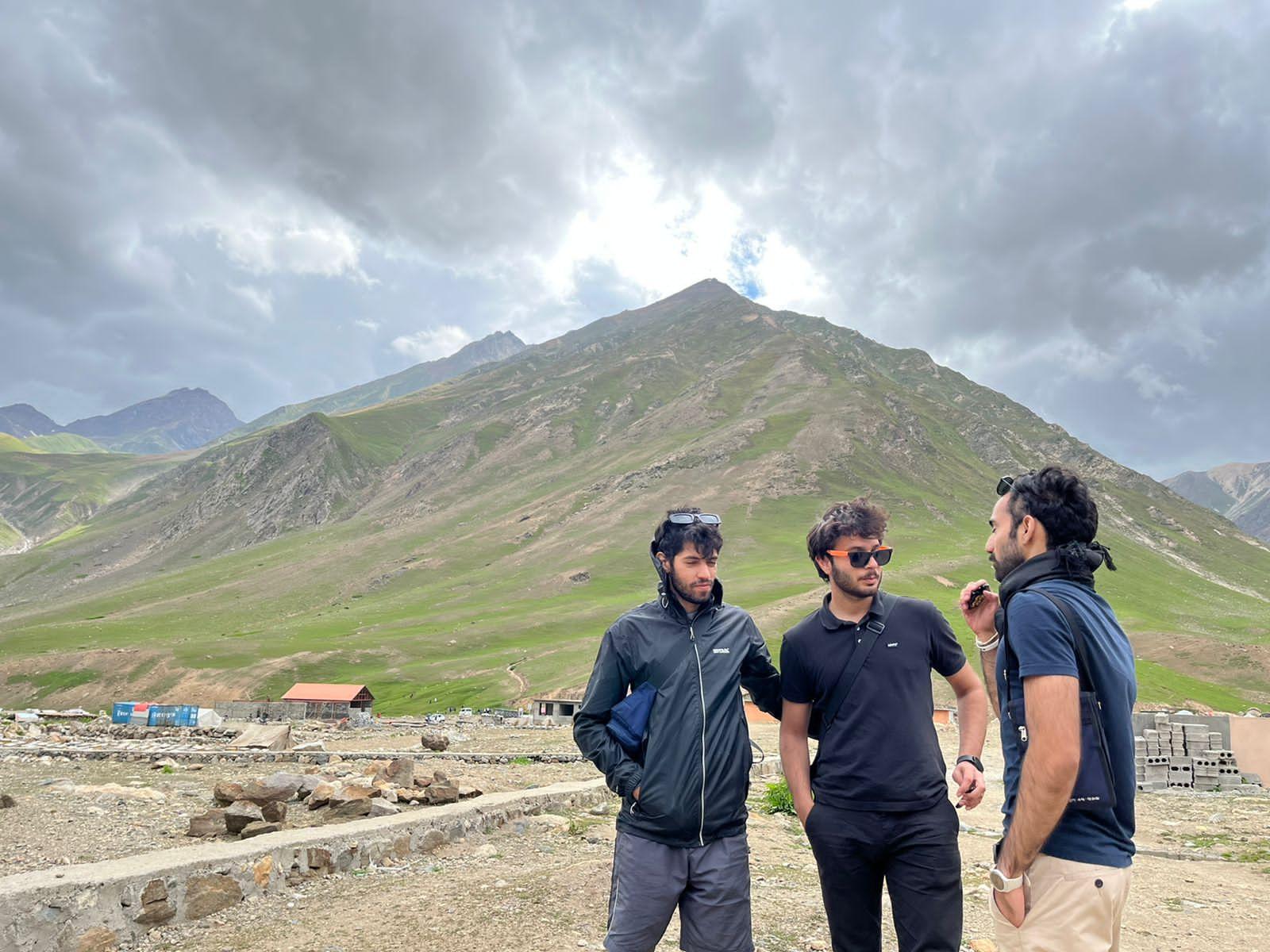 Portrait of 3Musafir founders with warm light and modern workspace